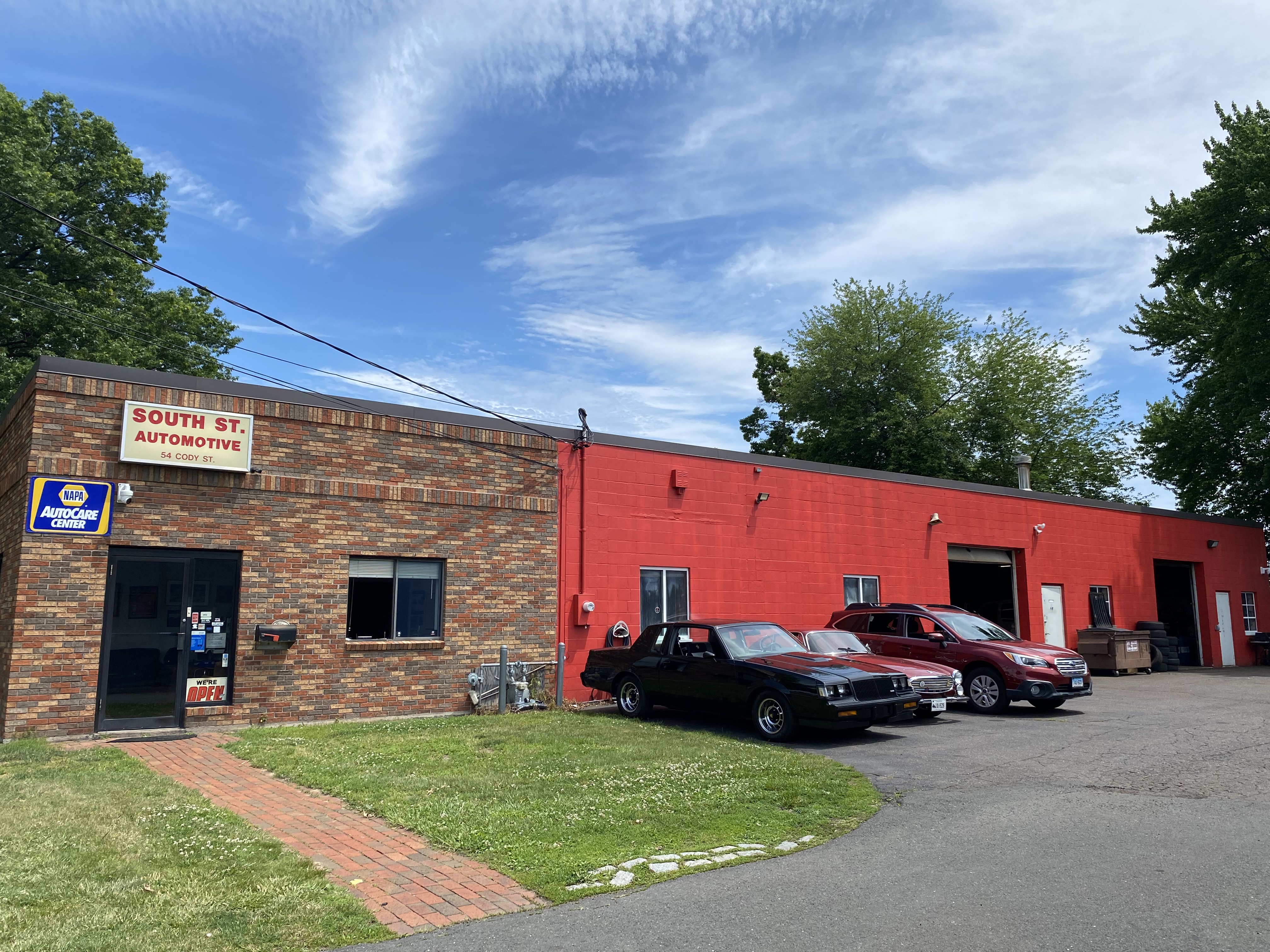 Technician working under the hood at South Street Automotive