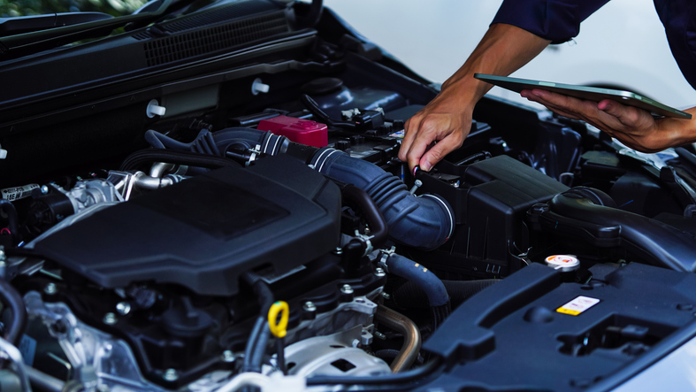 Technician working under the hood at South Street Automotive